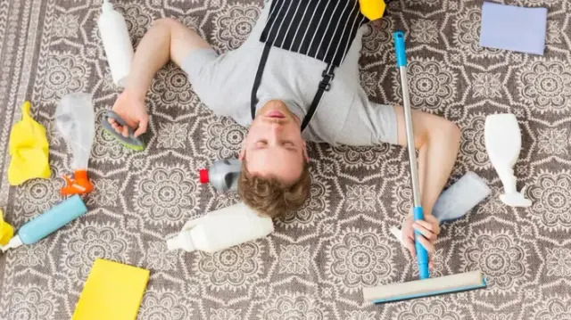 Wiping down surfaces to remove household dust